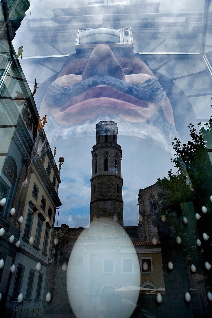 Church of Sant Pere Reflected in a Shop window of Dalí´s Theatre Museum, that houses a sculpture, Figueres.Girona province. Catalonia. Spain