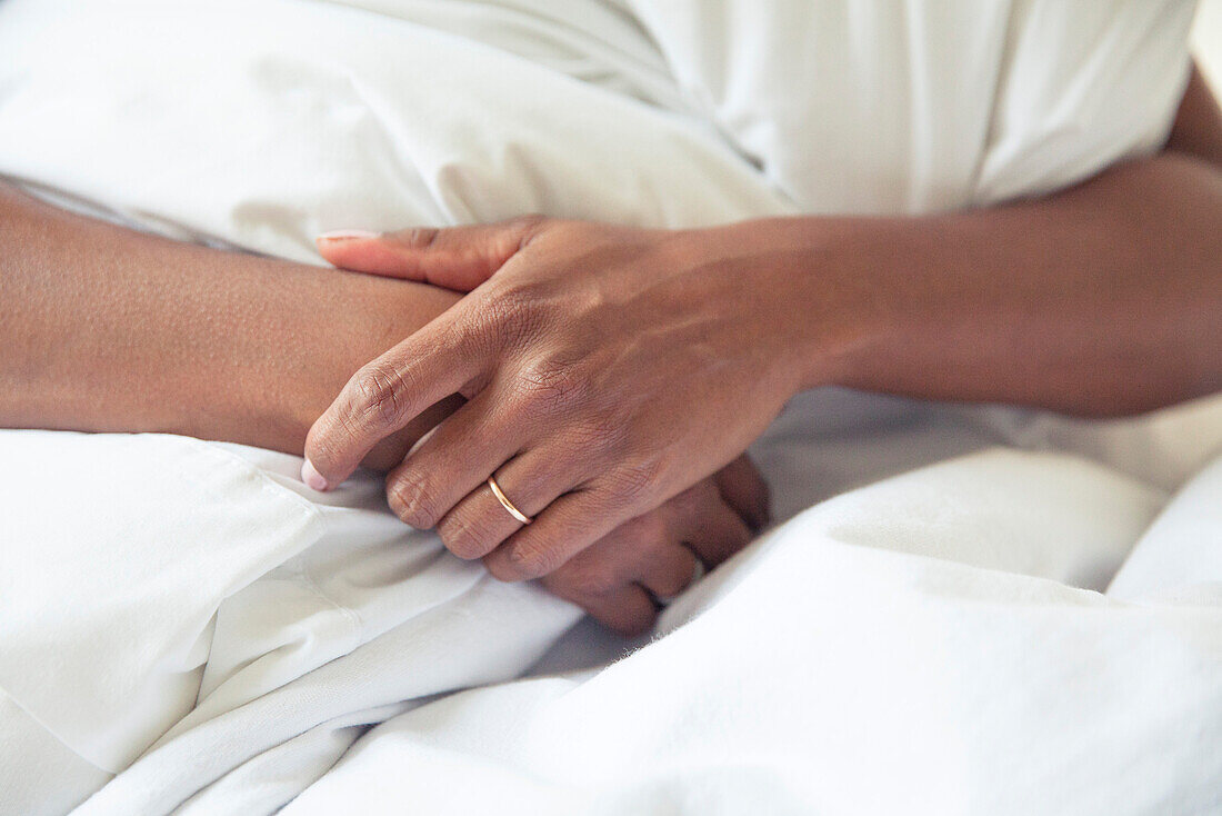 Woman's clasped hands, cropped