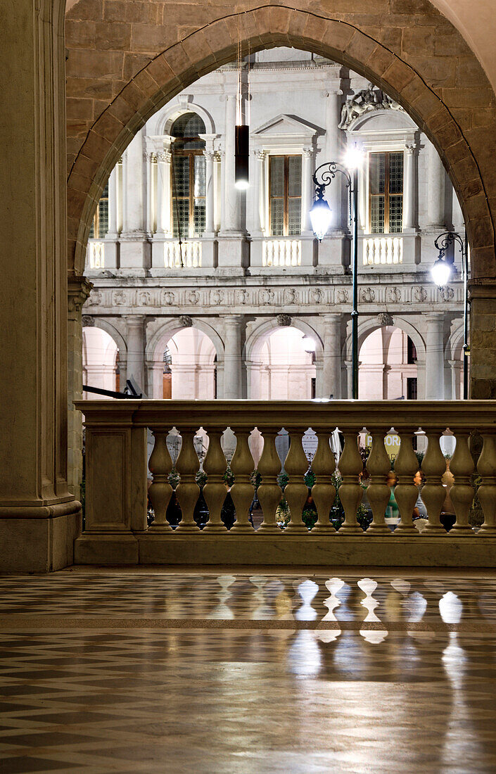 Arc of St. Alexander Cathedral entrance with his marble floor wich reflect lights and ancient parapet, Bergamo Alta, Lombardy, Italy