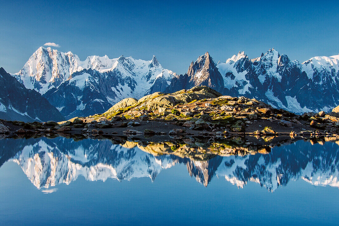 Snowy peaks of Dent Du Geant and Grandes Jorasses are reflected in Lac Blanc Haute Savoie France Europe