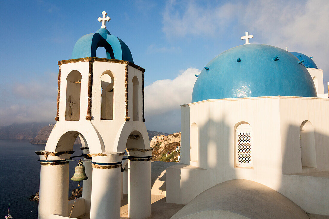 The blue domes of the churches dominate the Aegean Sea Santorini Cyclades Greece Europe