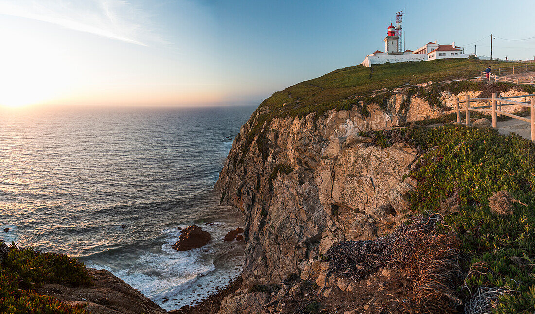 The colors of the sunset on the cape and lighthouse of Cabo da Roca overlooking the Atlantic Ocean Sintra Portugal Europe