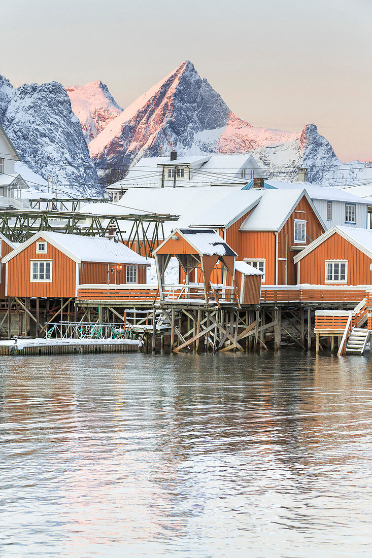 The colors of dawn frames the fishermen houses surrounded by snowy peaks Sakris?©y Reine Nordland Lofoten Islands Norway Europe