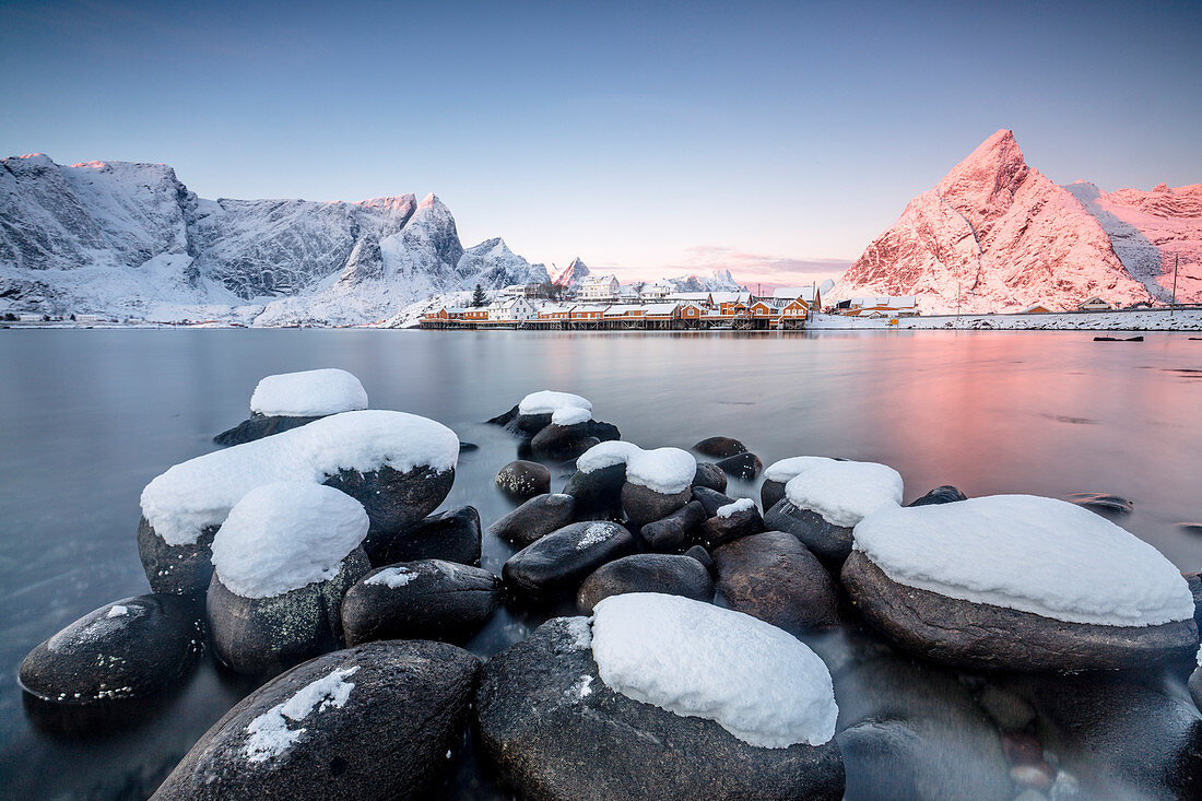 The colors of dawn frames the fishermen houses surrounded by frozen sea Sakris?©y Reine Nordland Lofoten Islands Norway Europe