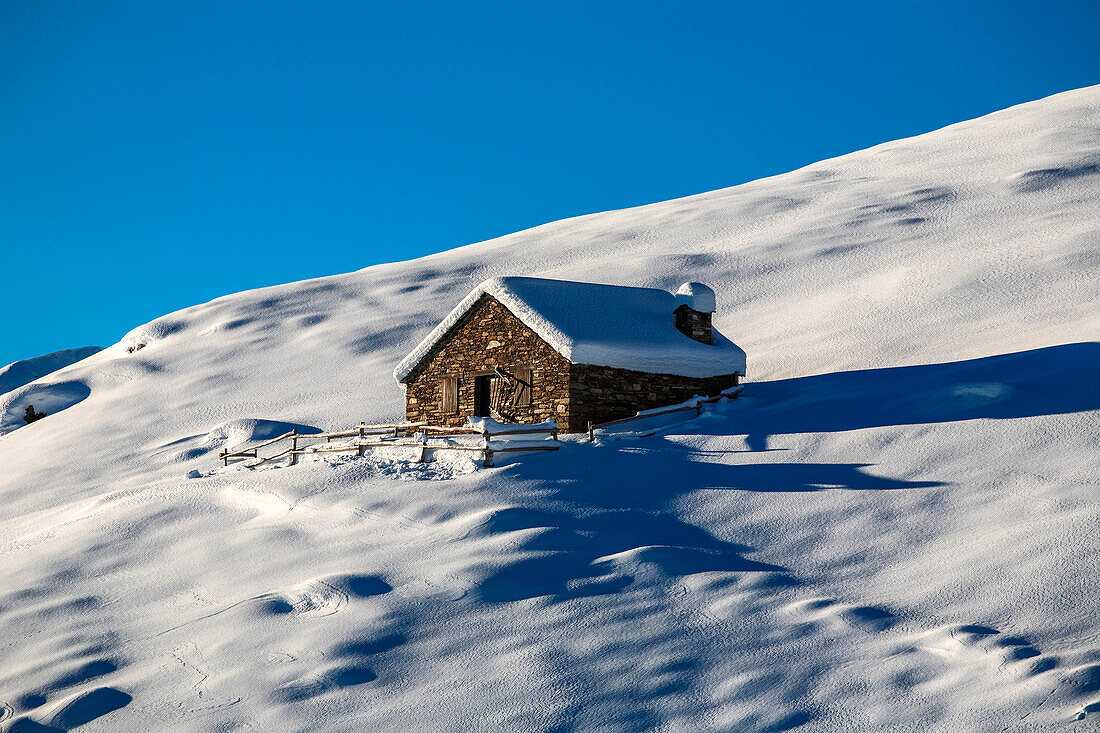 Orobie alps, Chalet in winter at Gerola valley, Lombardy, Italy