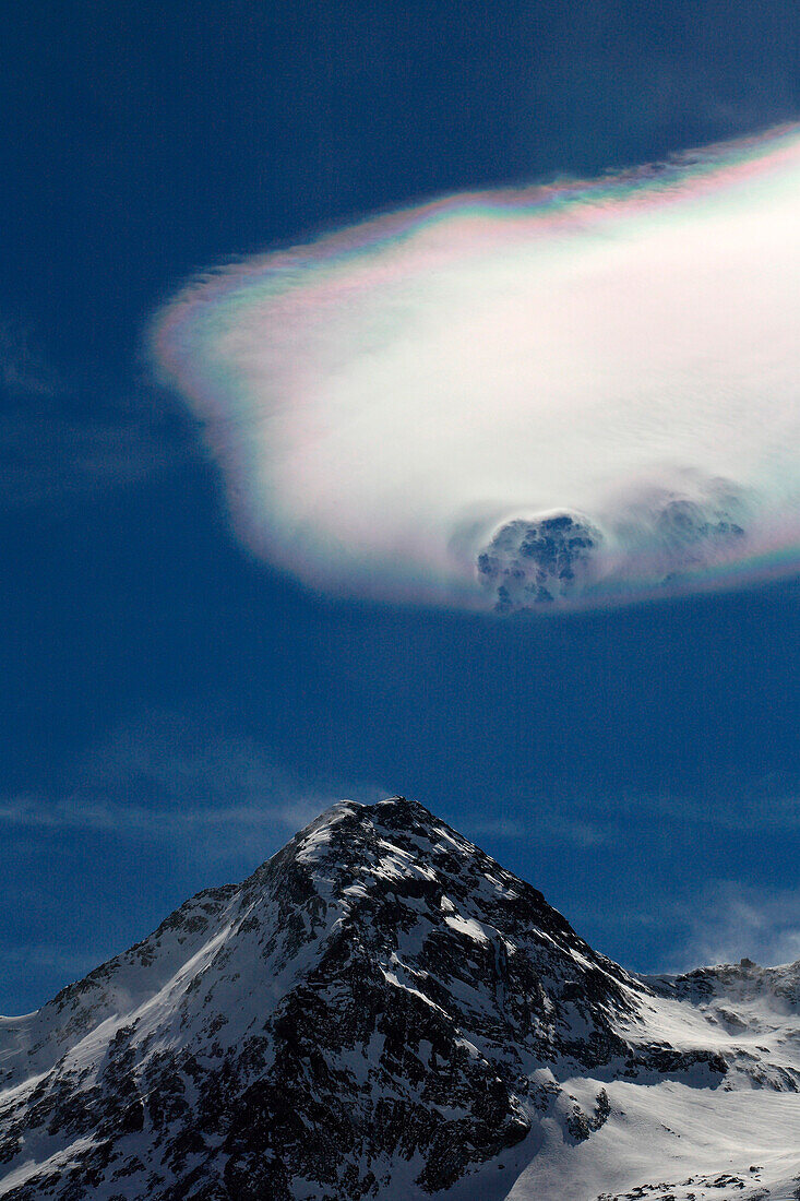 A cloud above the peak of Sassal Mason near the Bernina Pass, Engadine, Switzerland Europe