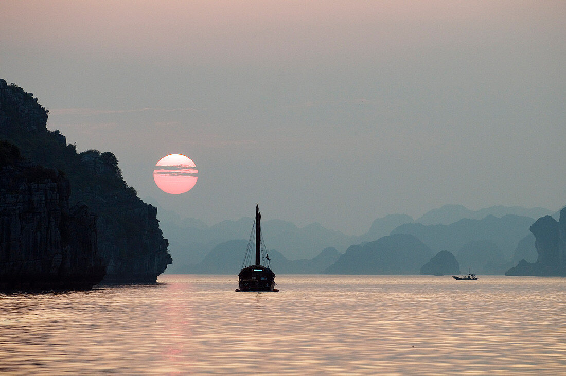 Vietnam, Along Bay, listed as World Heritage by UNESCO, sunset and junk