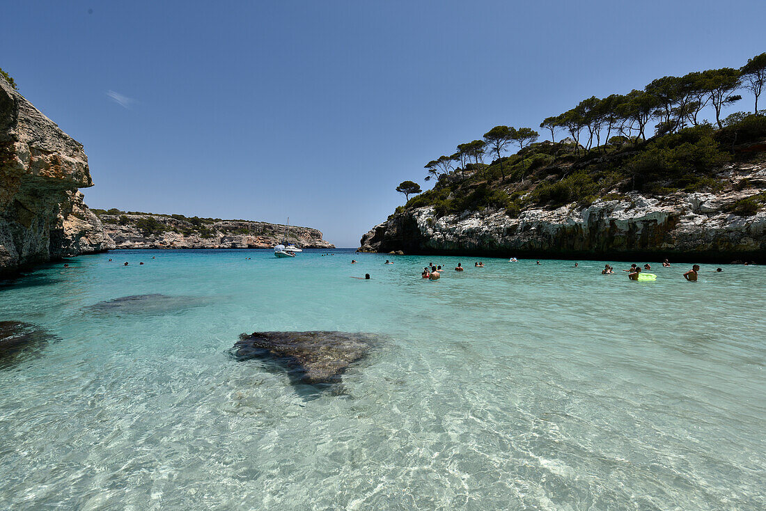 People swimming in the bay of Calo des Moro, Mallorca, Spain