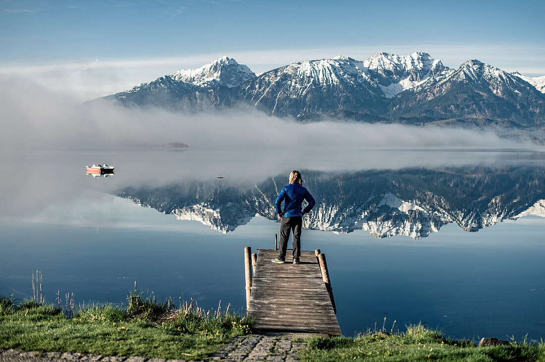 Lake Hopfensee, Hopfen am See, Peer, Man standing there and watching to the lake, lonliness, Allgaeu, Bavaria, Germany, Mountains, Snow, mist, Lake