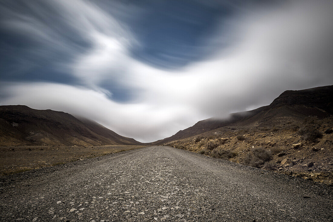 Passat clouds gather over the mountains at the Barranco de las Canarios in Jandia. Barranco de Los Canarios, Jandia, Fuerteventura, Canary Islands, Spain