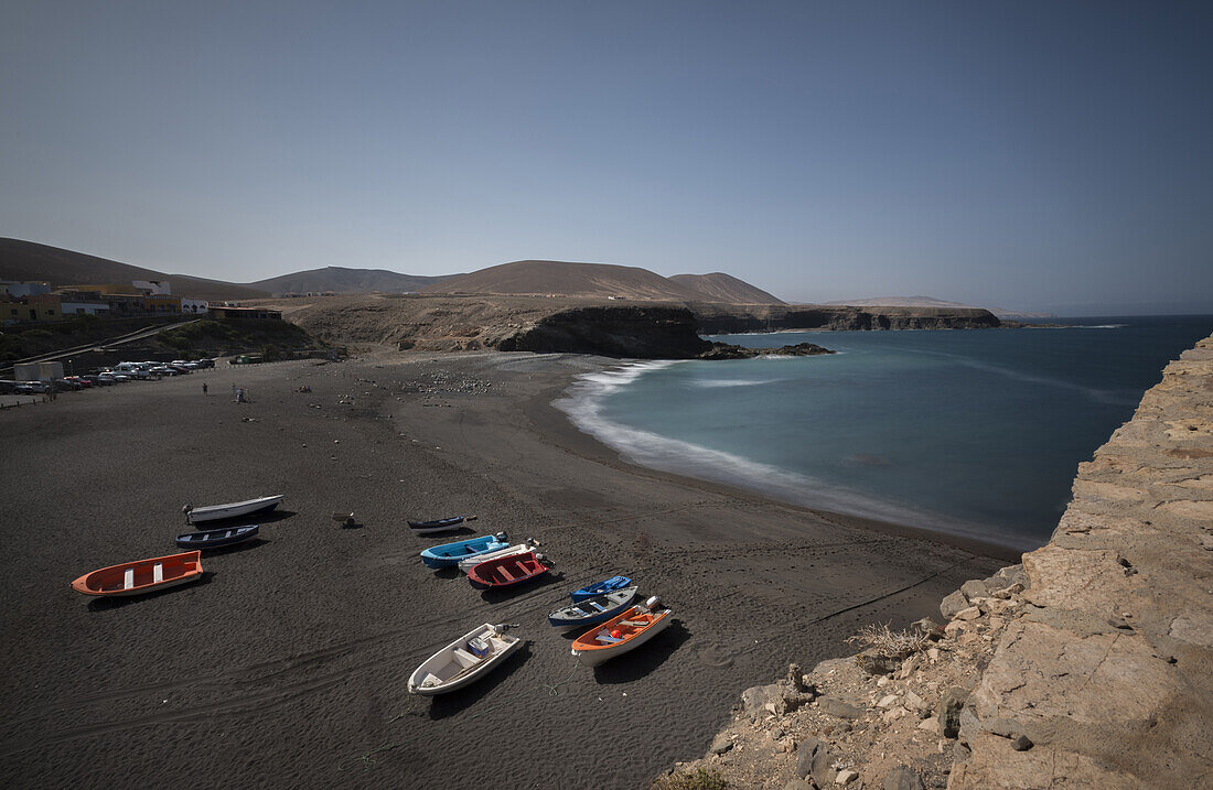Fishing boats on the beach with black sand in the fishing village Ajuy. Ajuy, Fuerteventura, Canary Islands, Spain