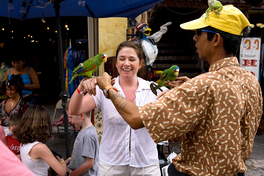 Mexico, state of Quintana Roo, Riviera Maya, Playa del Carmen, tourists taking pictures with birds