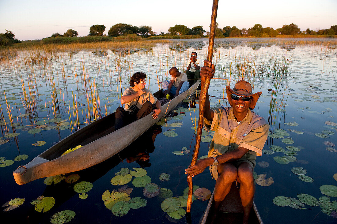 Botswana, North-west District, the Okavango Delta listed as World Heritage by UNESCO, crossing the marshes in mokoro, pirogue