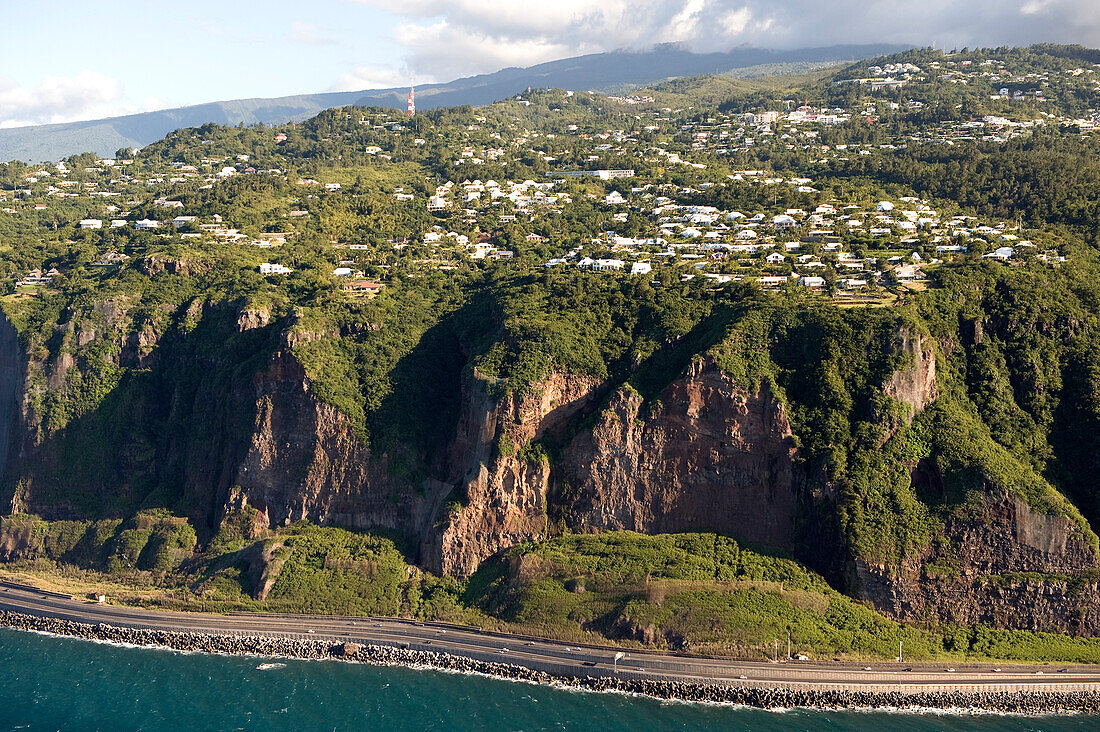 France, Reunion Island, the Route du Littoral (Coastal Road) at the foot of the cliffs between Le Port and Saint Denis (aerial view)