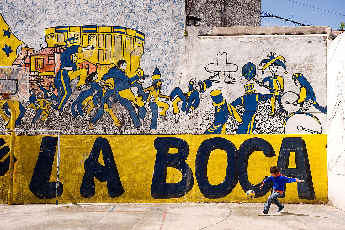 Argentina, Buenos Aires, La Boca District, child playing football