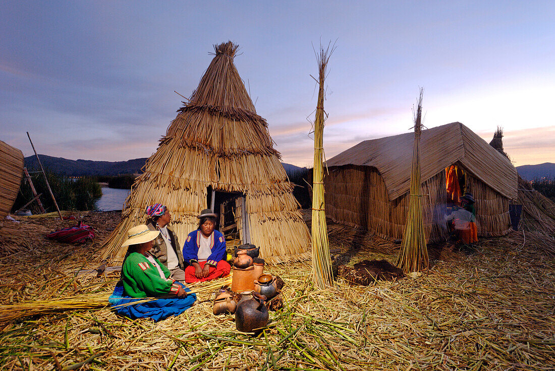 Peru, Puno Province, Titicaca lake, floating islands of Uros, evening family meal at home heated with dried reed