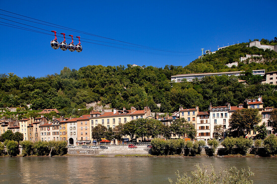France, Isere, Grenoble, Isere river bank with the Saint Laurent District surmounted by the Bastille linked by the most ancient urban cable car in the world