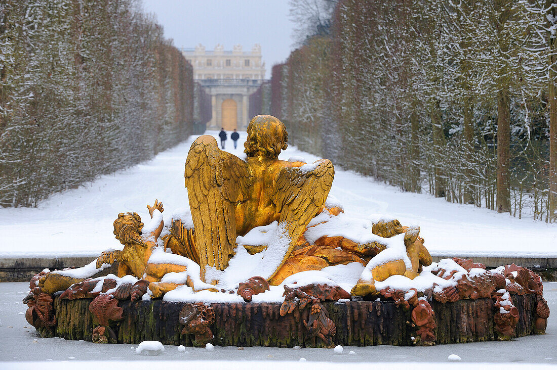 France, Yvelines, snow covered park of the Chateau de Versailles, listed as World Heritage by UNESCO, Saturn Basin also called the Winter Basin artwork by Girardon