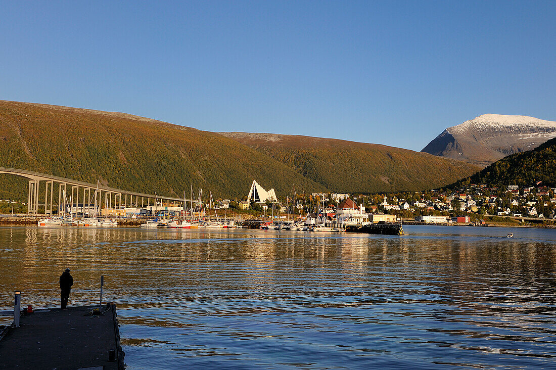 Norway, Troms County, Tromso harbour in Tromsesundet Fjord, the Arctic Cathedral and Tromsdalstind Mount (1238 m) in the background