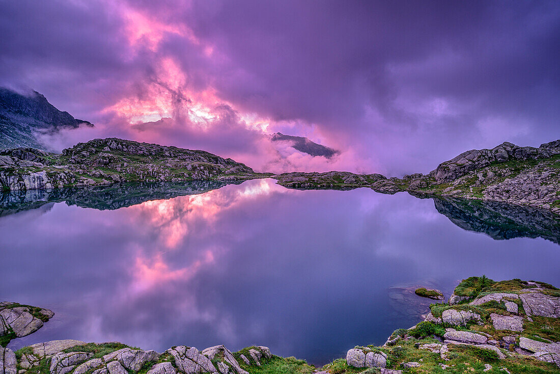 Mood of clouds above mountain lake, Lago Nero, Adamello-Presanella Group, Trentino, Italy