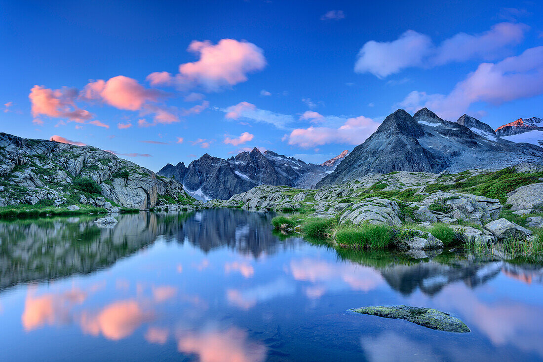 Mood of clouds at mountain lake with Crozzon di Lares and Lobbia Alta, hut rifugio Madron, Adamello-Presanella Group, Trentino, Italy