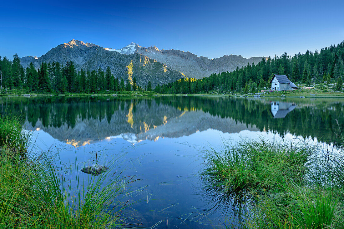 Mountain lake with chapel, Cima Presanella in background, lake lago San Giuliano, Val Genova, Adamello-Presanella Group, Trentino, Italy