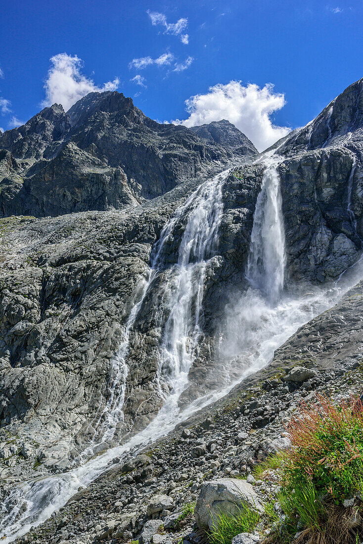Waterfall flowing over rockslab, hut rifugio Lobbia Alta, Val Genova, Adamello-Presanella Group, Trentino, Italy