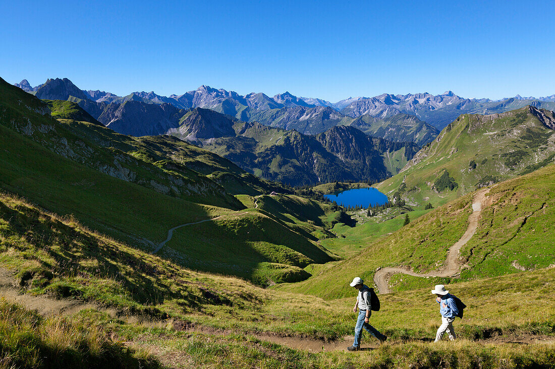 Hikers at Lake Seealpsee, at Nebelhorn, near Oberstdorf, Allgaeu Alps, Allgaeu, Bavaria, Germany