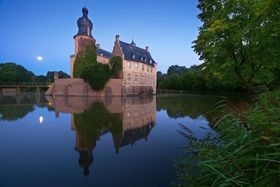 Moon reflecting in the moat, Gemen moated castle, Borken, Muensterland, North-Rhine Westphalia, Germany