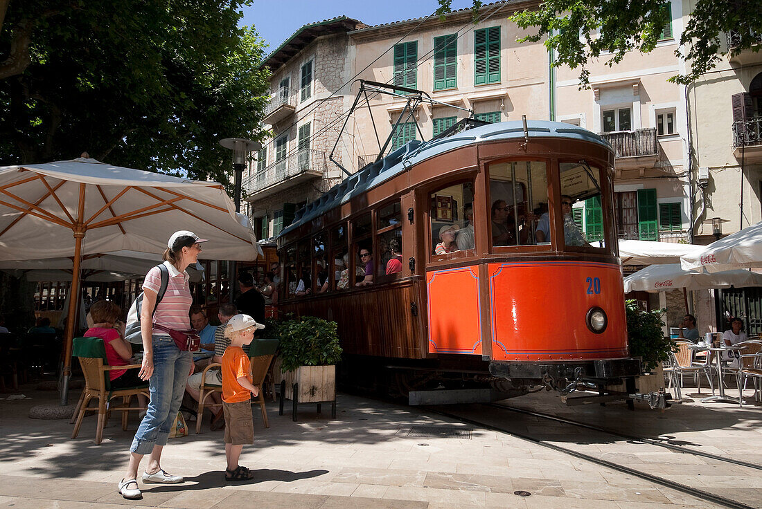 Spain, Balearic Islands, Majorca, Soller, the Orange Express tram crossing the city in the middle of cafe terraces than linking Puerto Soller on the coast