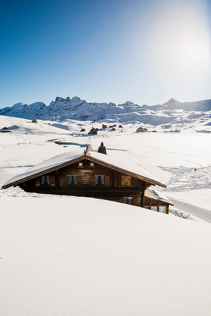 Traditional wooden chalet and snowy winter landscape, Melchsee-Frutt, Canton of Obwalden, Switzerland