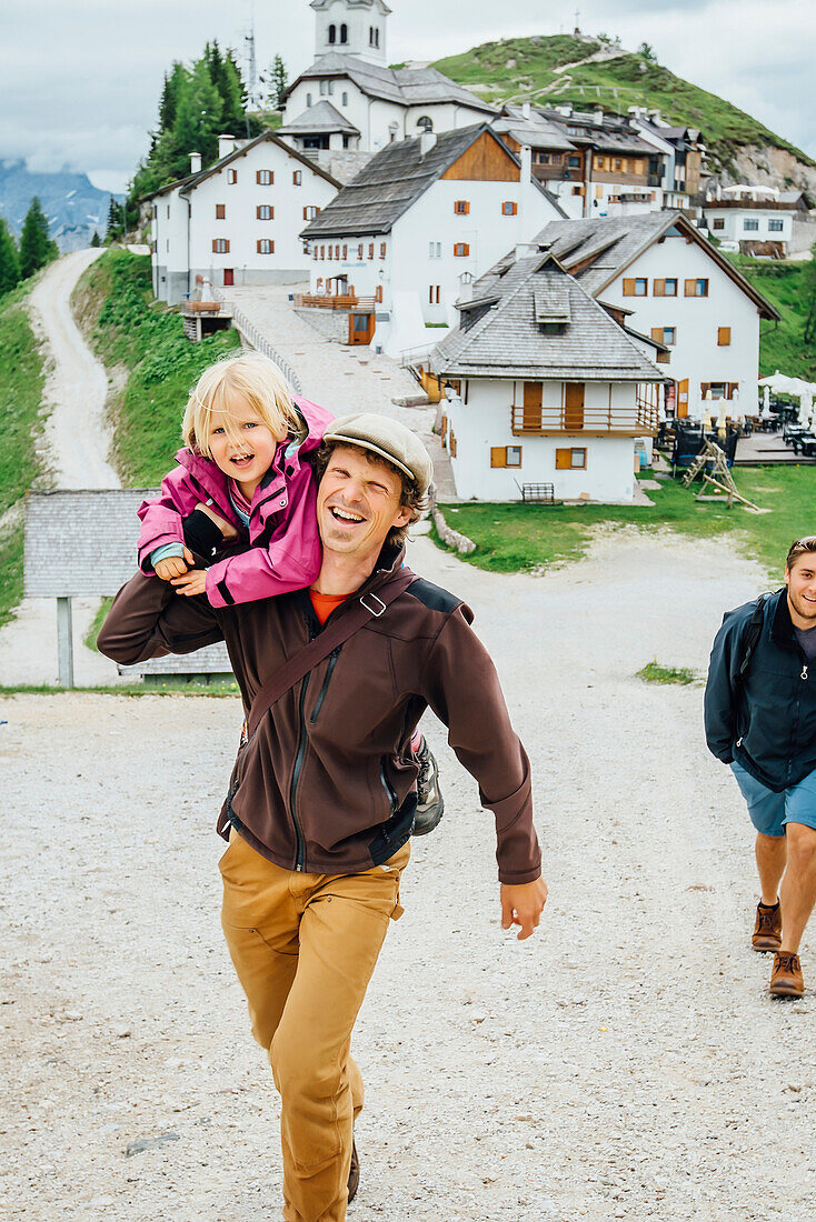 Caucasian father carrying daughter, Tarvisio, Vienna, Austria