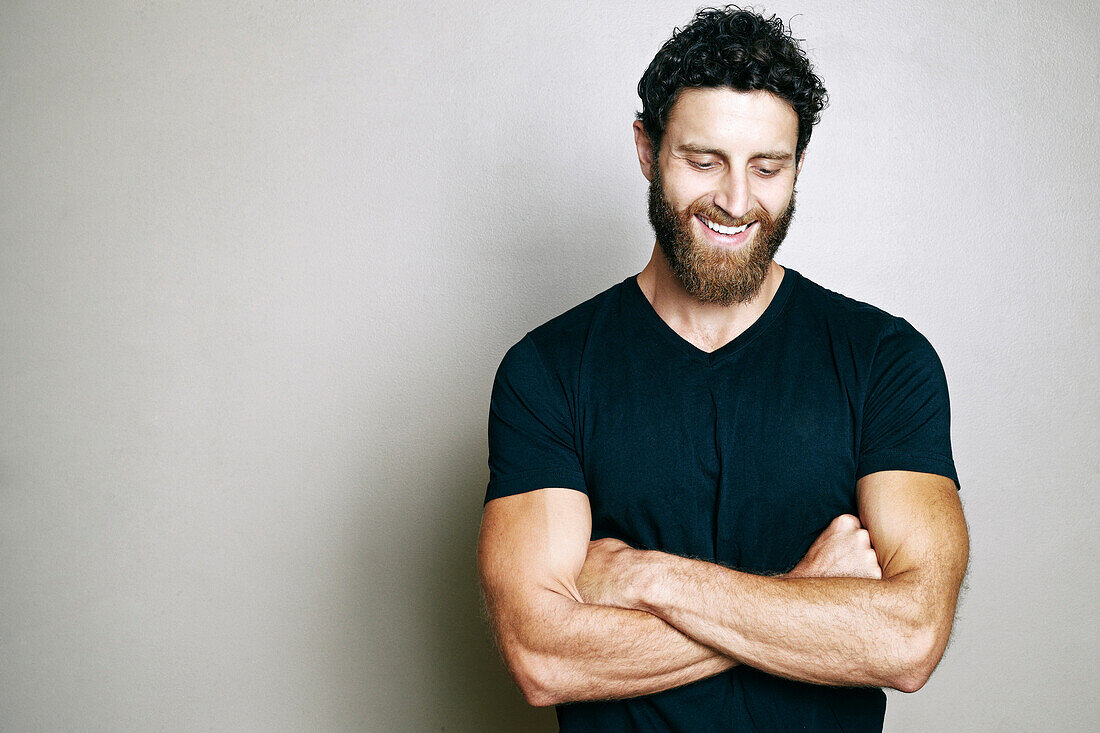 Smiling Caucasian man with beard looking down