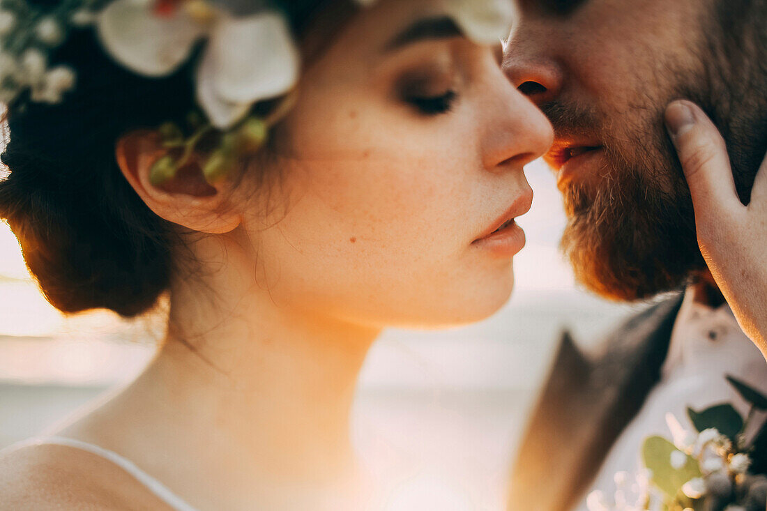 Caucasian bride and groom kissing