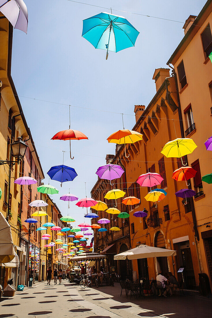 Multicolor umbrellas hanging over street, Bologna, Emilia-Romagna, Italy