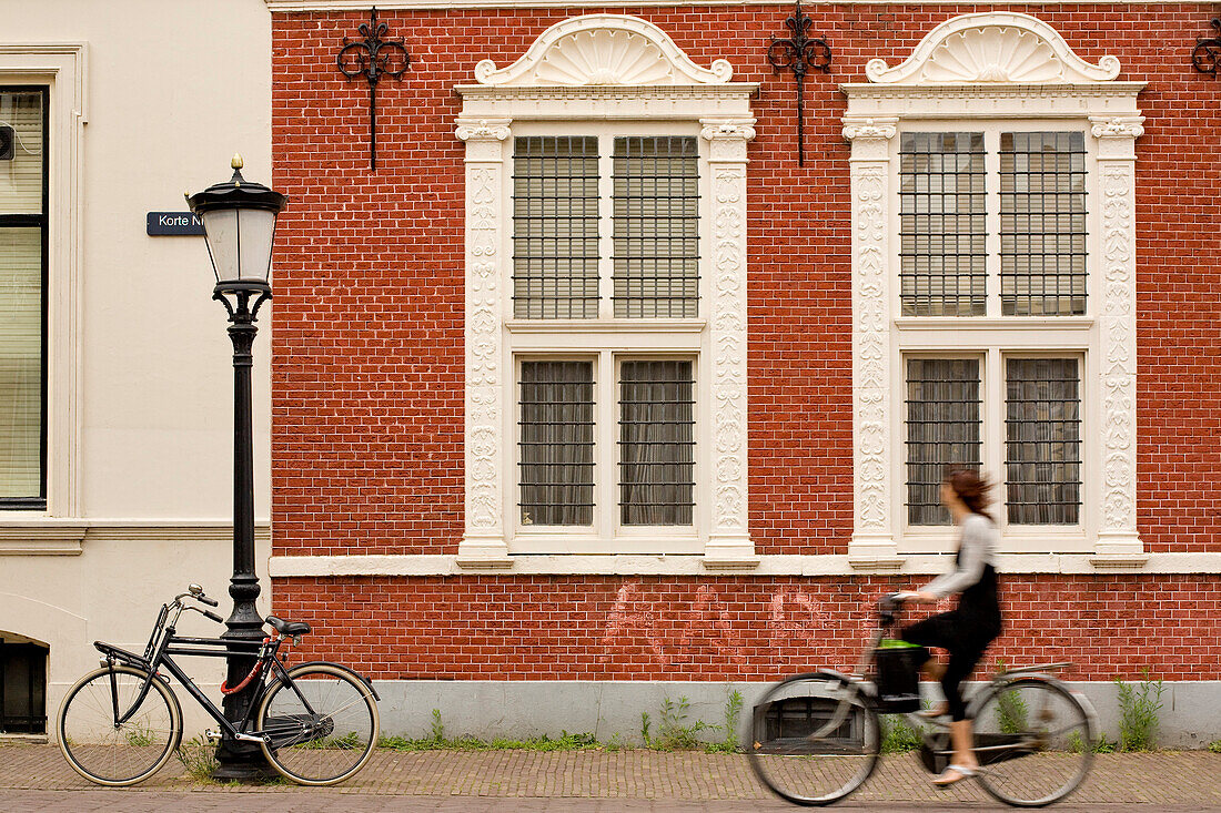 Netherlands, Southern Holland Province, Utrecht, Korte Nieuwstraat, before a cyclist old facade
