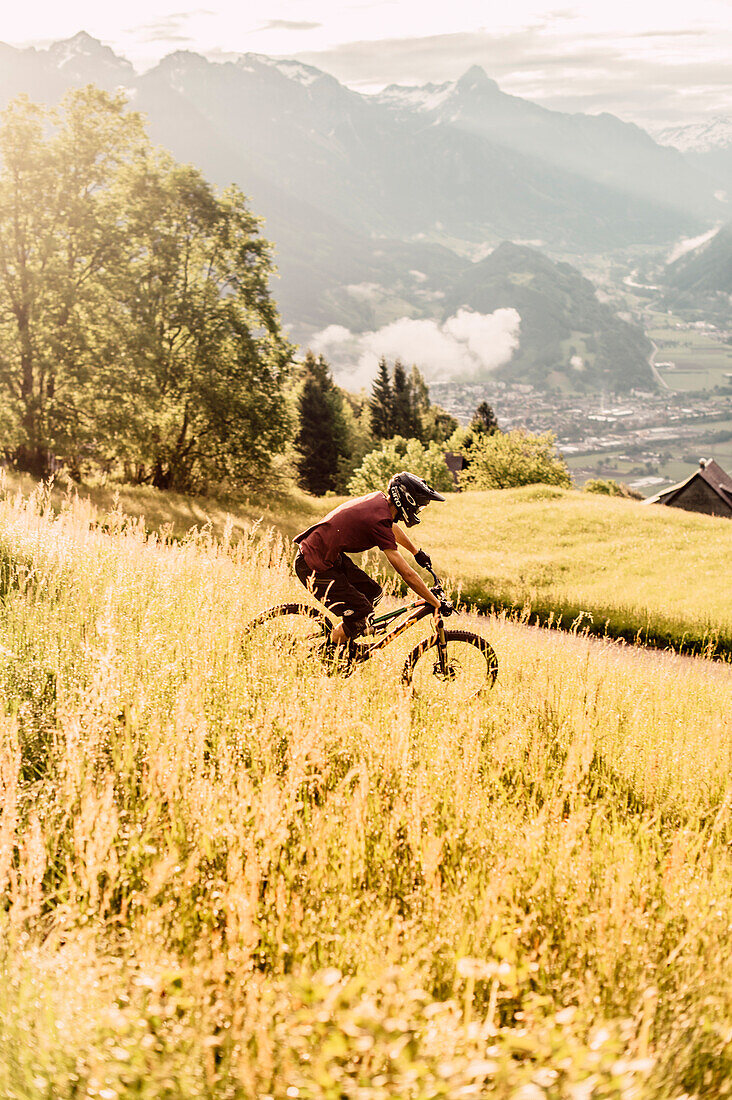 Mountainbiker within the mountains at sunrise, Brandnertal, Vorarlberg, Austria, Alps, Mountains, Downhill