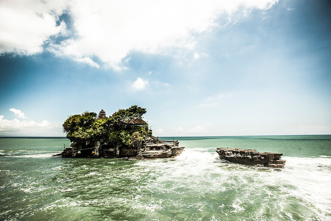 Tanah Lot, a temple built on a rock outcropping in the sea, sits off the southwestern coast of Bali, Indonesia