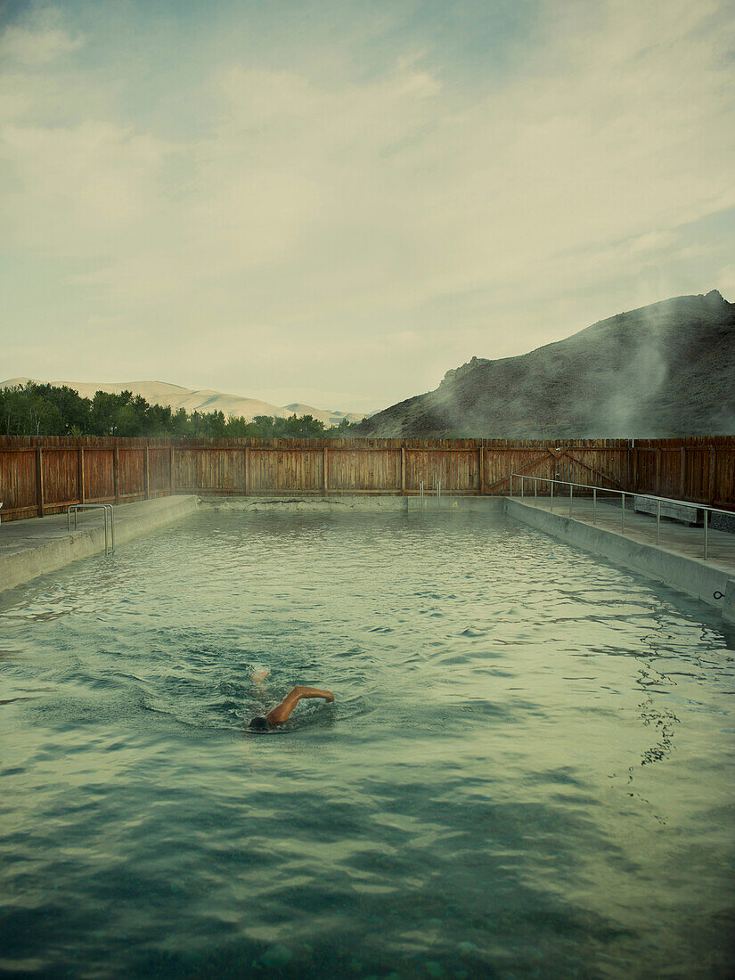 A man swims in a hot springs pool in Idaho.