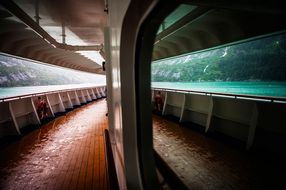 The scenic Tracy Arm on the Alaskan coast as seen from promenade deck of a cruise ship.