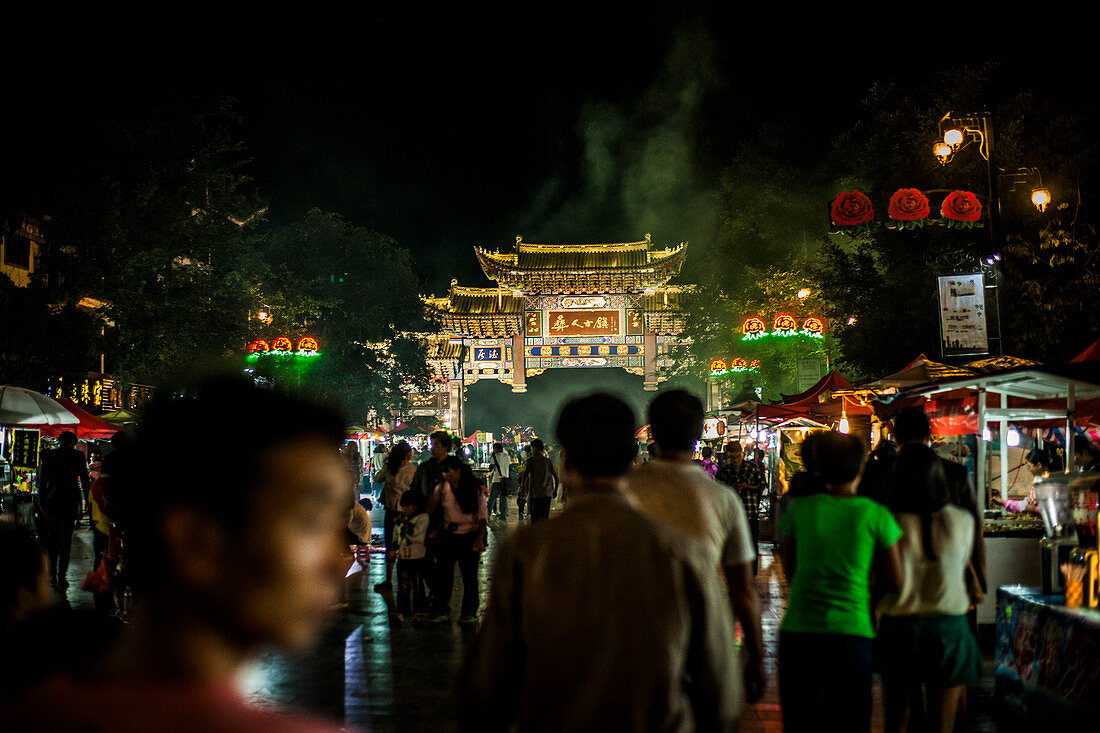 Shopping street and gate in Chuxiong, China at night