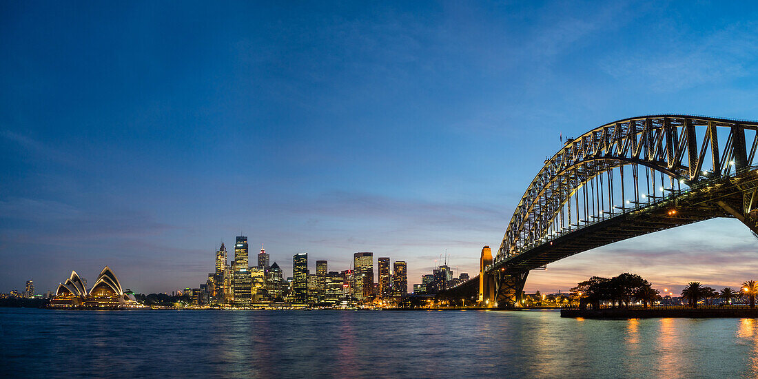Sydney's iconic buildings lit up as dusk settles over the city, Sydney, New South Wales, Australia, Pacific