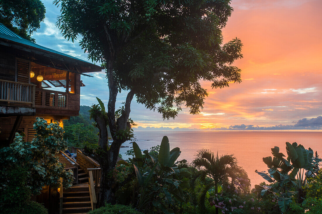 A tree house style apartment in the rainforest faces out to sea at sunset in Castara Bay in Tobago, Trinidad and Tobago, West Indies, Caribbean, Central America