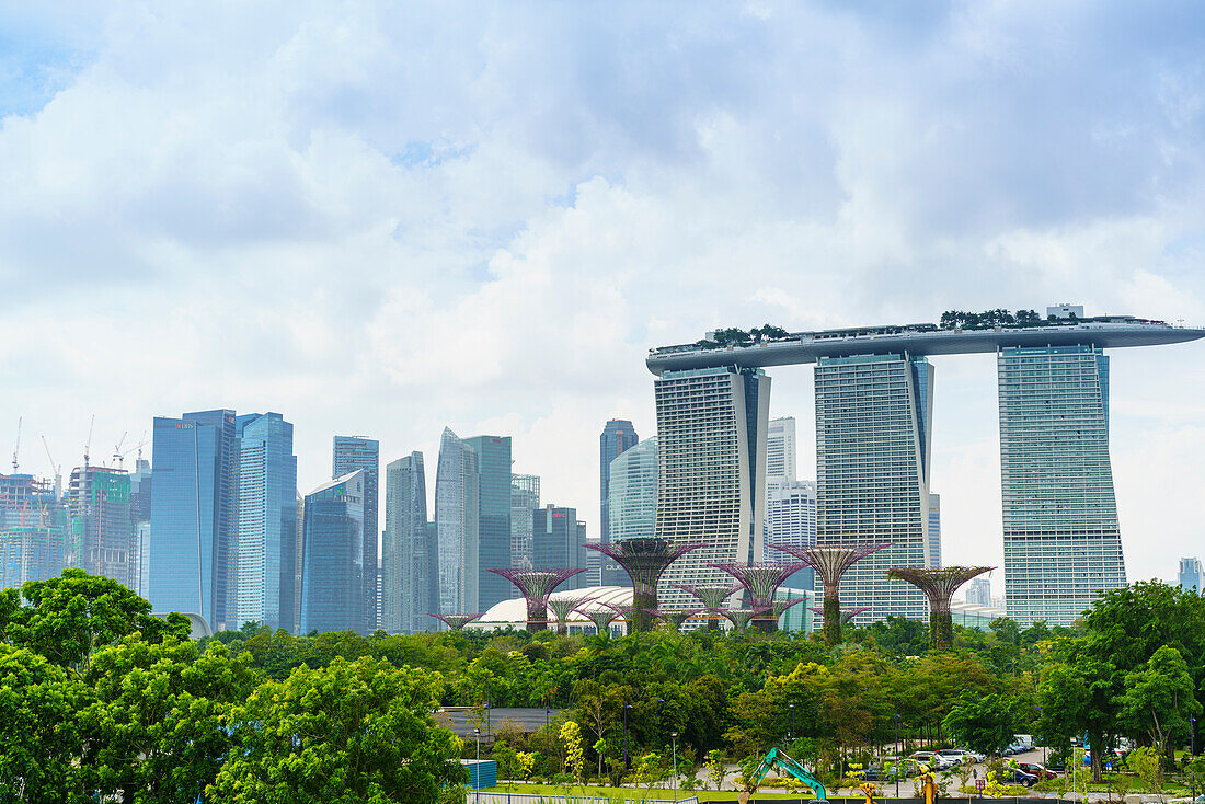 View over the Gardens by the Bay to the three towers of the Marina Bay Sands Hotel and city skyline beyond, Singapore, Southeast Asia, Asia