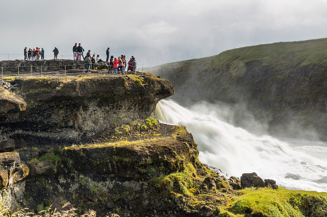 Tourists visiting Gullfoss (Golden Falls), a waterfall located in the canyon of the Hvita River in southwest Iceland, Polar Regiions