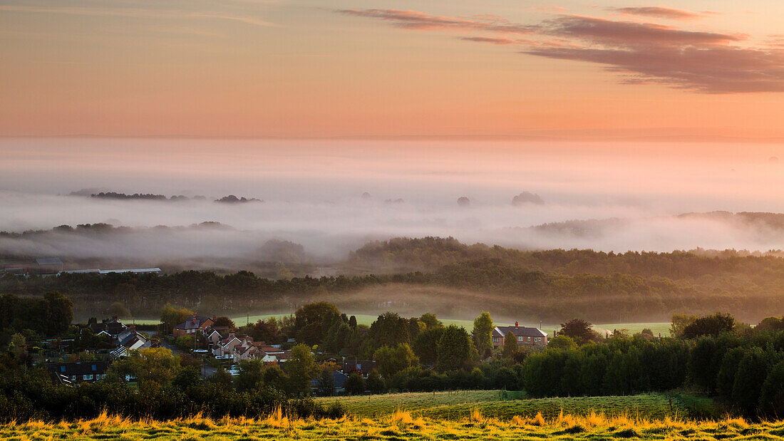 Looking over Delamere village from Eddisbury Hill on an autumn morning to a blanket of mist and fog lying on the Cheshire plain, Cheshire, England, United Kingdom, Europe