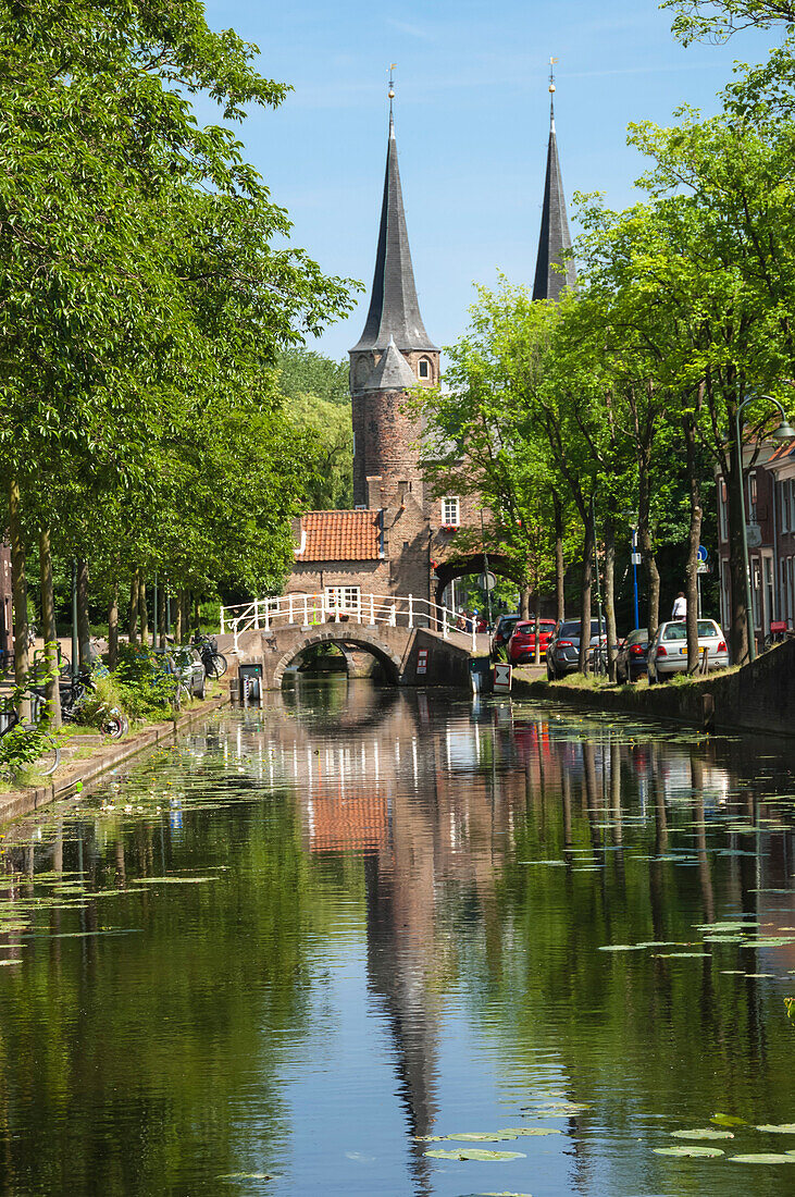 Canal scene with bridge, 16th century East Port Gate Towers, Delft, Holland, Europe