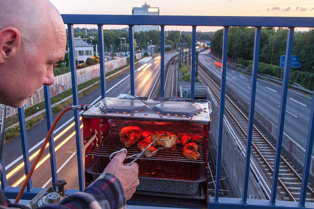 German Autobahn, man barbecues, grill on Autobahn bridge, A 40, motorway, highway, freeway, speed, speed limit, traffic, infrastructure, Essen, Germany