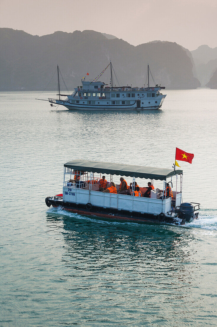 Vietnam, Halong Bay, tourist boats, dusk.