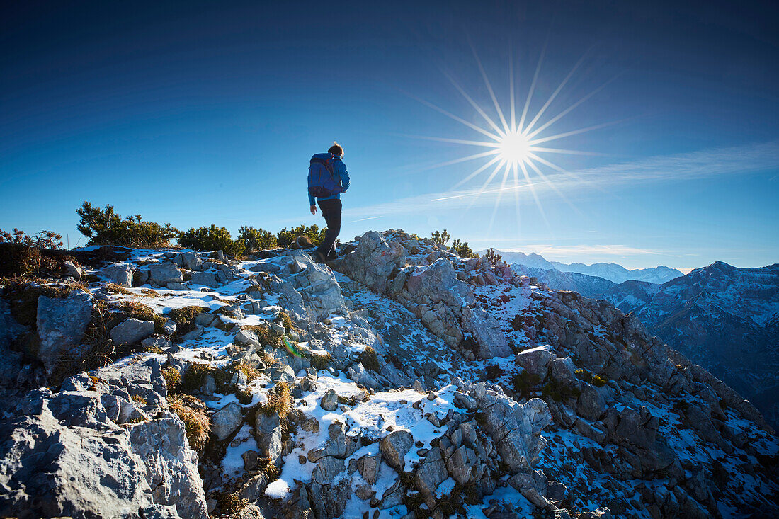 Hikers in the late Autumn at the summit of the Scheinbergspitze, Ammergauer Alps, Germany